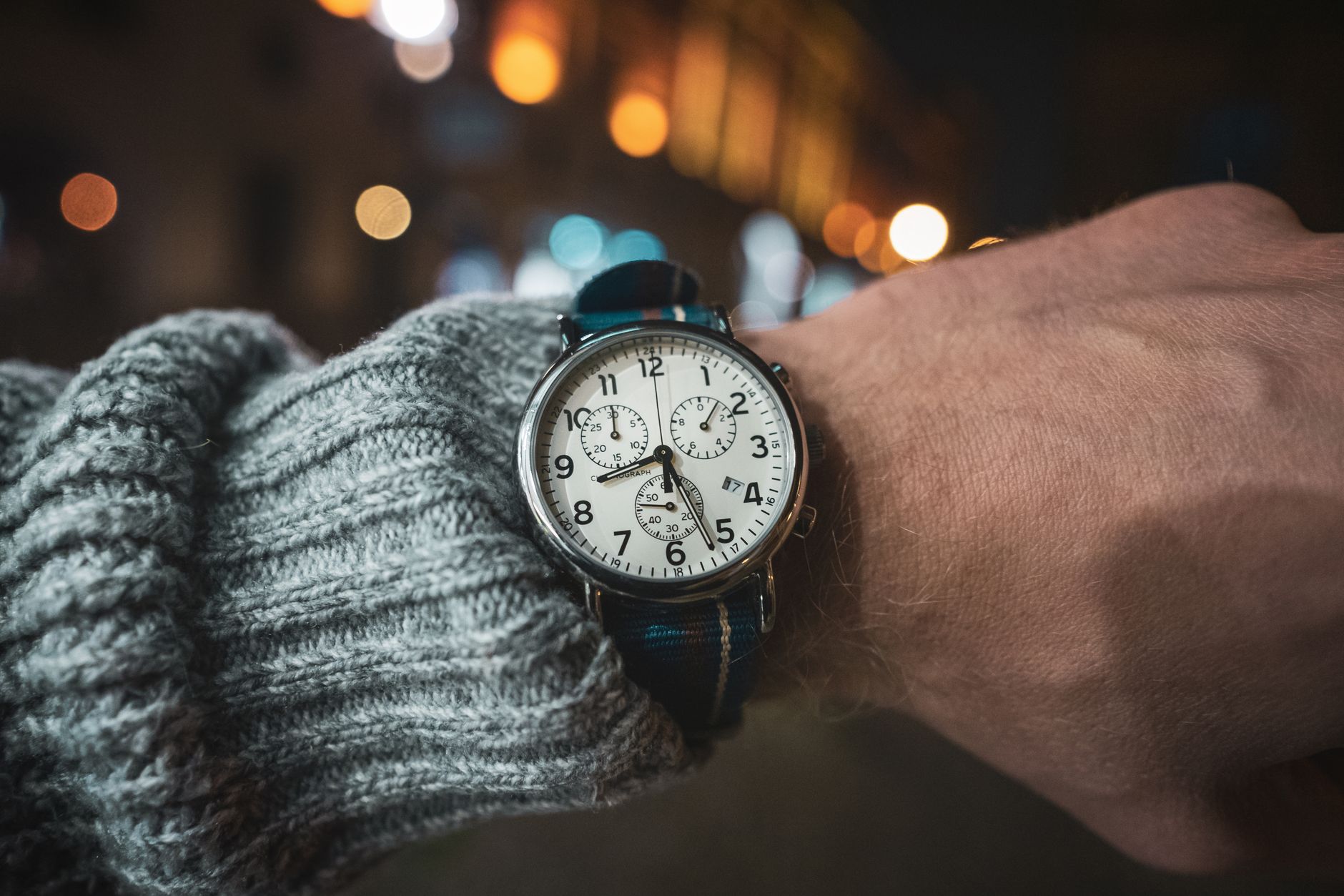 person wearing an analog chronograph wrist watch